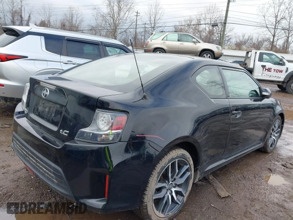 2014 Scion tC with VIN JTKJF5C74E3069104, listed as a IAAI auction lot 41579797 with 130,668 mi miles. Bid and sale history available at carsss.com. Image 4.