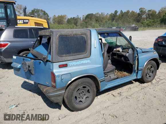 1995 Geo Tracker z VIN 2CNBE18UXS6930601, wystawiony jako Copart lot #76079094 z przebiegiem 276 136 mil mil oraz Szkody całkowita. Historia ofert i sprzedaży dostępna na DreamBid. Obrazek 3.