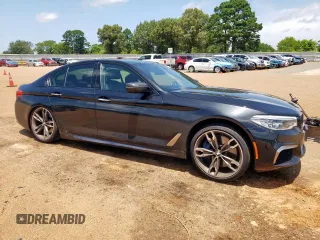 2018 BMW 5 Series M550i xDrive with VIN WBAJB9C54JB286450, listed as a Copart auction lot 61232125 with 88,479 mi miles and Salvage title. Bid and sale history available at DreamBid. Image 4.