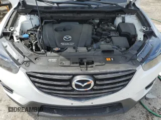 2016 Mazda CX-5 Grand Touring z VIN JM3KE2DYXG0731462, wystawiony jako Copart lot #58220465 z przebiegiem 130 033 mil mil oraz Szkoda całkowita • Salvage title. Historia ofert i sprzedaży dostępna na DreamBid. Obrazek 12.