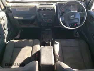 2006 Jeep Wrangler Sport Right Hand Drive with VIN 1J4F449S76P747454, listed as a Copart auction lot 77819214 with 184,763 mi miles and Salvage Title. Bid and sale history available at carsss.com. Image 8.