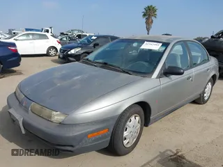 1999 Saturn SL z VIN 1G8ZH5280XZ249494, wystawiony jako IAAI lot #42347493 z przebiegiem 106 491 mil mil oraz . Historia ofert i sprzedaży dostępna na DreamBid. Obrazek 2.