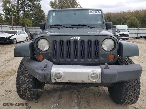 2011 Jeep Wrangler Unlimited Sahara with VIN 1J4BA5H16BL557068, listed as a Copart auction lot 80429454 with 142,428 mi miles and Salvage Title. Bid and sale history available at carsss.com. Image 5.