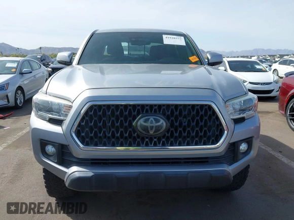 2018 Toyota Tacoma SR5 with VIN 3TMAZ5CN0JM053861, listed as a IAAI auction lot 41920377 with 104,015 mi miles and . Bid and sale history available at DreamBid. Image 12.