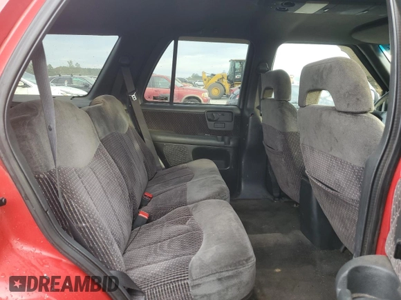 1996 GMC Jimmy SL z VIN 1GKDT13WXT2502347, wystawiony jako Copart lot #74502444 z przebiegiem 253 735 mil mil oraz Szkoda całkowita • Salvage title. Historia ofert i sprzedaży dostępna na DreamBid. Obrazek 11.