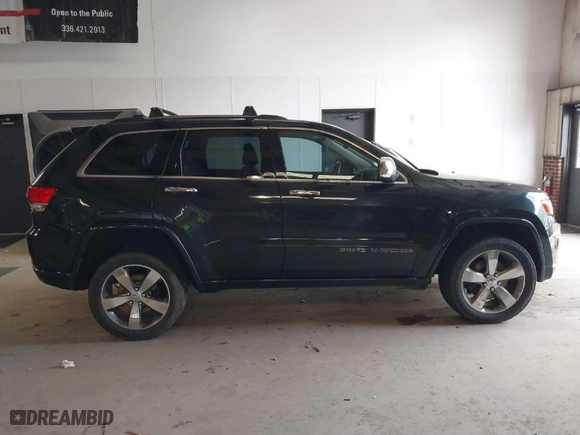 2014 Jeep Grand Cherokee Overland with VIN 1C4RJFCM4EC386398, listed as a IAAI auction lot 41696113 with 119,110 mi miles. Bid and sale history available at carsss.com. Image 13.