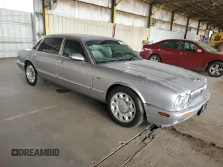 2000 Jaguar XJ with VIN SAJDA25B8YMF04079, listed as a Copart auction lot 50592595 with 131,647 mi miles and Salvage title. Bid and sale history available at DreamBid. Image 4.