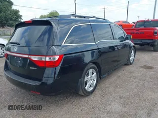 2013 Honda Odyssey Touring with VIN 5FNRL5H95DB086041, listed as a IAAI auction lot 42477974 with 213,343 mi miles and . Bid and sale history available at DreamBid. Image 4.