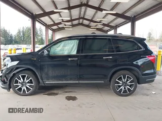2021 Honda Pilot Elite with VIN 5FNYF6H04MB043014, listed as a IAAI auction lot 41826931 with 63,546 mi miles and . Bid and sale history available at DreamBid. Image 14.