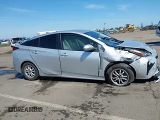2021 Toyota Prius L Eco with VIN JTDKAMFUXM3144991, listed as a IAAI auction lot 42147025 with 106,466 mi miles and . Bid and sale history available at DreamBid. Image 12.
