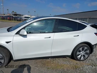 2024 Tesla Model Y with VIN 7SAYGDED2RF017448, listed as a IAAI auction lot 41597056 with 9,702 mi miles and . Bid and sale history available at DreamBid. Image 14.