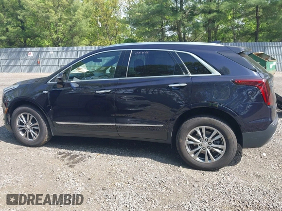 2021 Cadillac XT5 AWD Premium Luxury z VIN 1GYKNDRS8MZ217572, wystawiony jako IAAI lot #42190571 z przebiegiem 25 100 mil mil oraz . Historia ofert i sprzedaży dostępna na DreamBid. Obrazek 14.