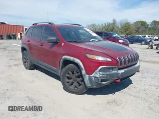 2015 Jeep Cherokee Trailhawk with VIN 1C4PJMBS1FW640483, listed as a IAAI auction lot 41883688 with 103,589 mi miles. Bid and sale history available at carsss.com. Image 1.