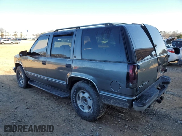 1999 GMC Yukon with VIN 1GKEK13R3XJ750307, listed as a Copart auction lot 84728104 with 212,879 mi miles and Salvage Title. Bid and sale history available at carsss.com. Image 2.