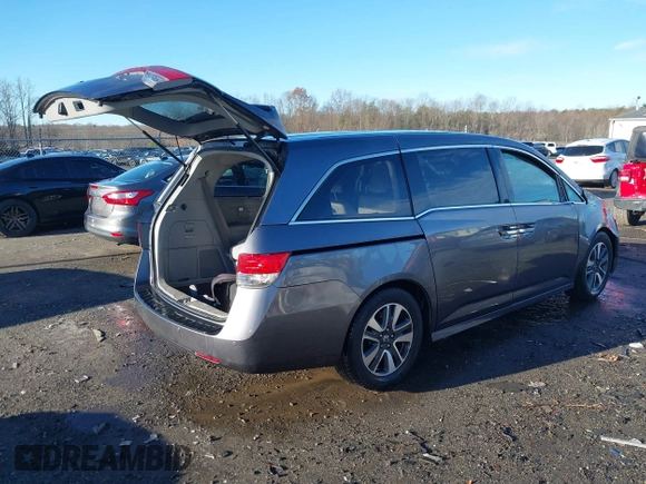 2014 Honda Odyssey Touring with VIN 5FNRL5H94EB081267, listed as a IAAI auction lot 41199509 with 146,827 mi miles and . Bid and sale history available at DreamBid. Image 4.