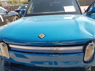 2025 Rivian R1S Adventure with VIN 7PDSGBBA9SN056202, listed as a IAAI auction lot 40766927 with 1,688 mi miles. Bid and sale history available at carsss.com. Image 10.