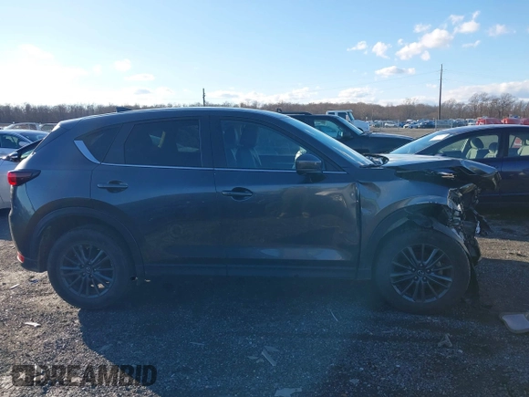 2021 Mazda CX-5 Touring with VIN JM3KFBCM8M1370640, listed as a IAAI auction lot 41207736 with 57,570 mi miles. Bid and sale history available at carsss.com. Image 14.
