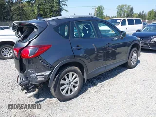 2015 Mazda CX-5 Sport z VIN JM3KE4BY5F0540612, wystawiony jako IAAI lot #42109082 z przebiegiem 83 874 mil mil oraz . Historia ofert i sprzedaży dostępna na DreamBid. Obrazek 4.