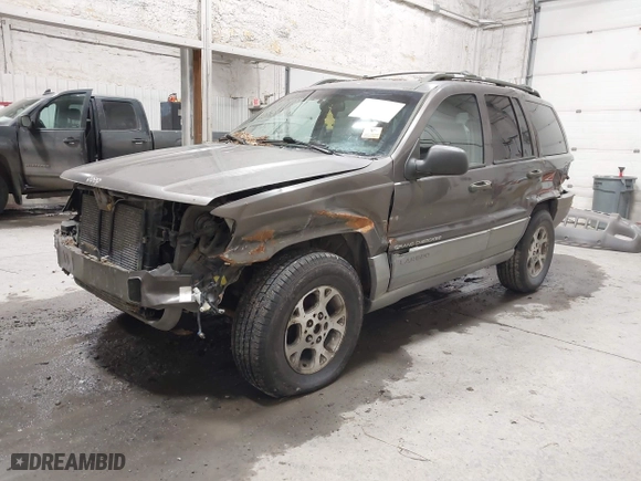 1999 Jeep Grand Cherokee Laredo with VIN 1J4GW58SXXC584734, listed as a IAAI auction lot 41902224 with 209,180 mi miles. Bid and sale history available at carsss.com. Image 2.
