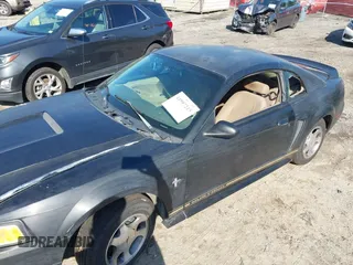 2000 Ford Mustang z VIN 1FAFP404XYF217165, wystawiony jako IAAI lot #41997215 z przebiegiem Nie podano mil oraz . Historia ofert i sprzedaży dostępna na DreamBid. Obrazek 6.