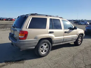 1999 Jeep Grand Cherokee Laredo z VIN 1J4GW58NXXC704719, wystawiony jako Copart lot #49546395 z przebiegiem 276 716 mil mil oraz Czysty tytuł • Clean title. Historia ofert i sprzedaży dostępna na DreamBid. Obrazek 3.