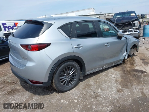 2020 Mazda CX-5 Touring with VIN JM3KFACM9L0785464, listed as a IAAI auction lot 42023311 with 90,062 mi miles and . Bid and sale history available at DreamBid. Image 4.