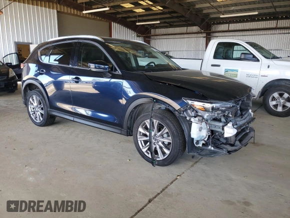 2019 Mazda CX-5 Grand Touring with VIN JM3KFADM3K1539890, listed as a Copart auction lot 57809835 with 56,079 mi miles and Salvage title. Bid and sale history available at DreamBid. Image 4.