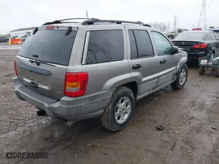 1999 Jeep Grand Cherokee Laredo with VIN 1J4GW58N0XC748809, listed as a IAAI auction lot 41722910 with 201,407 mi miles. Bid and sale history available at carsss.com. Image 4.
