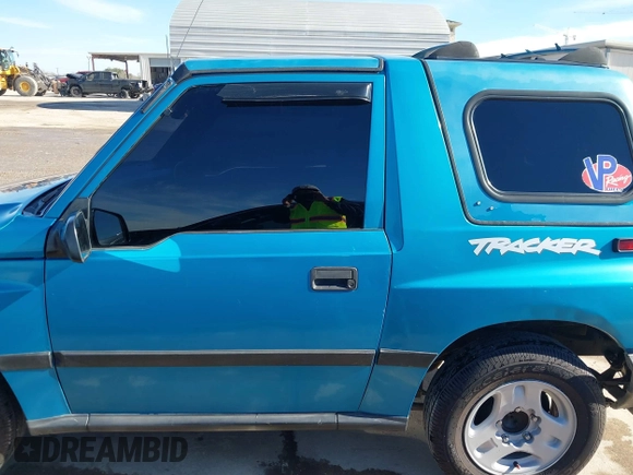 1997 Chevrolet Tracker z VIN 2CNBE1865V6904672, wystawiony jako IAAI lot #41296166 z przebiegiem 266 743 mil mil oraz . Historia ofert i sprzedaży dostępna na DreamBid. Obrazek 14.