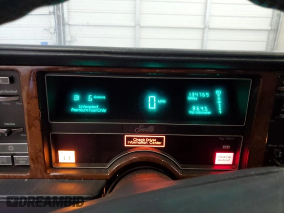 1991 Cadillac Seville z VIN 1G6KS53B2MU809384, wystawiony jako Copart lot #77185134 z przebiegiem 134 769 mil mil oraz Szkody całkowita. Historia ofert i sprzedaży dostępna na DreamBid. Obrazek 9.