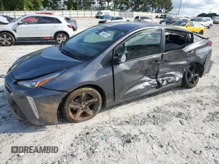 2022 Toyota Prius L Eco z VIN JTDKAMFU8N3173133, wystawiony jako Copart lot #54865615 z przebiegiem 100 876 mil mil oraz Szkoda całkowita • Salvage title. Historia ofert i sprzedaży dostępna na DreamBid. Obrazek 1.