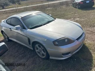 2005 Hyundai Tiburon GT z VIN KMHHN65F85U183258, wystawiony jako Copart lot #86871524 z przebiegiem 281 902 mil mil oraz Tytuł czysty. Historia ofert i sprzedaży dostępna na DreamBid. Obrazek 1.