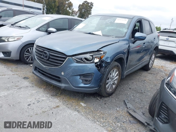 2016 Mazda CX-5 Touring z VIN JM3KE2CY2G0699138, wystawiony jako IAAI lot #42153228 z przebiegiem 144 191 mil mil oraz . Historia ofert i sprzedaży dostępna na DreamBid. Obrazek 2.