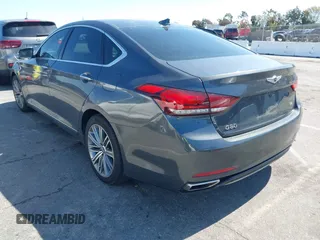 2018 Genesis G80 3.8L z VIN KMHGN4JEXJU283935, wystawiony jako IAAI lot #41750441 z przebiegiem 70 165 mil mil oraz . Historia ofert i sprzedaży dostępna na DreamBid. Obrazek 3.