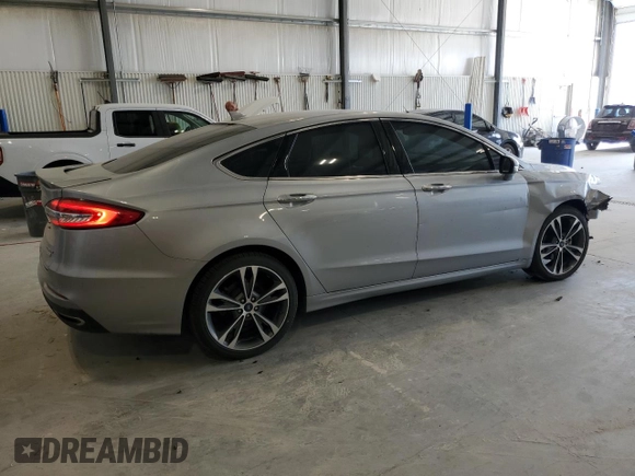 2020 Ford Fusion Titanium с VIN 3FA6P0K90LR112034, выставлен на аукционе Copart как лот 56740025 с пробегом 89 117 миль миль и Списание • Salvage title. История ставок и продаж доступна на DreamBid. Изображение 3.