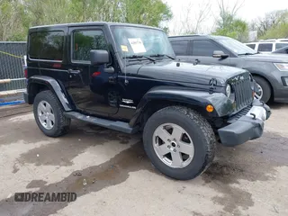2011 Jeep Wrangler Sahara with VIN 1J4GA5D1XBL559112, listed as a IAAI auction lot 42002738 with 107,759 mi miles and . Bid and sale history available at carsss.com. Image 1.