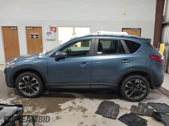 2016 Mazda CX-5 Grand Touring z VIN JM3KE4DY9G0714468, wystawiony jako IAAI lot #41860956 z przebiegiem 114 481 mil mil oraz . Historia ofert i sprzedaży dostępna na DreamBid. Obrazek 14.