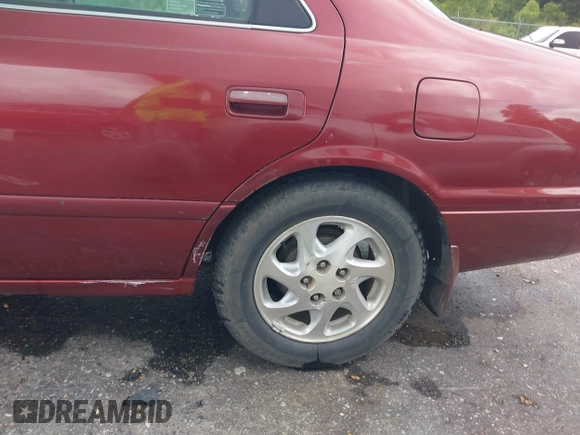 2000 Toyota Camry CE z VIN JT2BG22K3Y0521541, wystawiony jako IAAI lot #42074772 z przebiegiem 144 587 mil mil oraz . Historia ofert i sprzedaży dostępna na DreamBid. Obrazek 18.