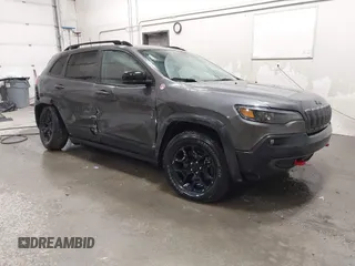 2022 Jeep Cherokee Trailhawk z VIN 1C4PJMBX9ND514703, wystawiony jako IAAI lot #41761037 z przebiegiem 38 499 mil mil oraz . Historia ofert i sprzedaży dostępna na DreamBid. Obrazek 1.