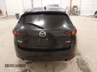 2021 Mazda CX-5 Touring with VIN JM3KFBCM1M1380409, listed as a IAAI auction lot 41677537 with 55,319 mi miles. Bid and sale history available at carsss.com. Image 16.
