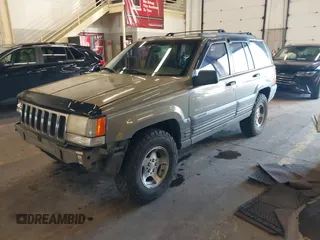 1996 Jeep Grand Cherokee Laredo with VIN 1J4GZ58S9TC293787, listed as a IAAI auction lot 41179368 with 141,755 mi miles. Bid and sale history available at carsss.com. Image 2.