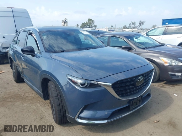 2021 Mazda CX-9 Carbon Edition z VIN JM3TCBDY0M0526352, wystawiony jako IAAI lot #42403901 z przebiegiem 50 193 mil mil oraz . Historia ofert i sprzedaży dostępna na DreamBid. Obrazek 1.