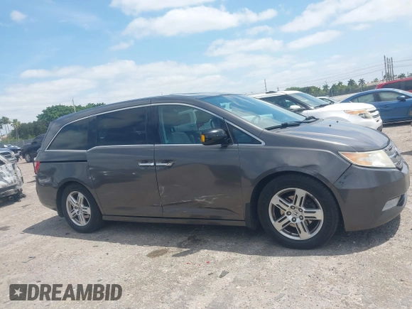 2012 Honda Odyssey Touring with VIN 5FNRL5H90CB088536, listed as a IAAI auction lot 42102008 with 283,350 mi miles and . Bid and sale history available at DreamBid. Image 13.