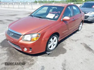 2009 Kia Spectra EX with VIN KNAFE221195026956, listed as a IAAI auction lot 42019309 with 121,341 mi miles. Bid and sale history available at carsss.com. Image 2.
