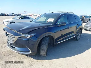 2016 Mazda CX-9 Grand Touring with VIN JM3TCADY6G0107064, listed as a IAAI auction lot 42580485 with 124,713 mi miles and . Bid and sale history available at DreamBid. Image 2.