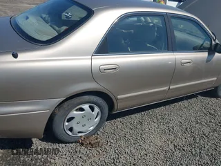 1999 Mazda 626 ES z VIN 1YVGF22C5X5811946, wystawiony jako IAAI lot #41970165 z przebiegiem 126 709 mil mil oraz . Historia ofert i sprzedaży dostępna na DreamBid. Obrazek 6.