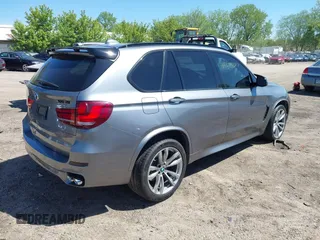 2014 BMW X5 xDrive50i with VIN 5UXKR6C57E0J72301, listed as a IAAI auction lot 39379887 with 117,012 mi miles. Bid and sale history available at carsss.com. Image 4.