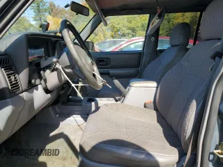 1998 Jeep Cherokee Sport with VIN 1J4FT68S4WL121559, listed as a Copart auction lot 77387794 with 163,453 mi miles and Salvage Title. Bid and sale history available at carsss.com. Image 7.