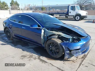 2018 Tesla Model 3 Long Range Battery with VIN 5YJ3E1EA4JF011799, listed as a IAAI auction lot 41765860 with 133,098 mi miles. Bid and sale history available at carsss.com. Image 1.