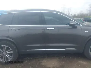 2020 Cadillac XT6 FWD Premium Luxury z VIN 1GYKPCRS0LZ136228, wystawiony jako IAAI lot #41912953 z przebiegiem Nie podano mil oraz . Historia ofert i sprzedaży dostępna na DreamBid. Obrazek 14.